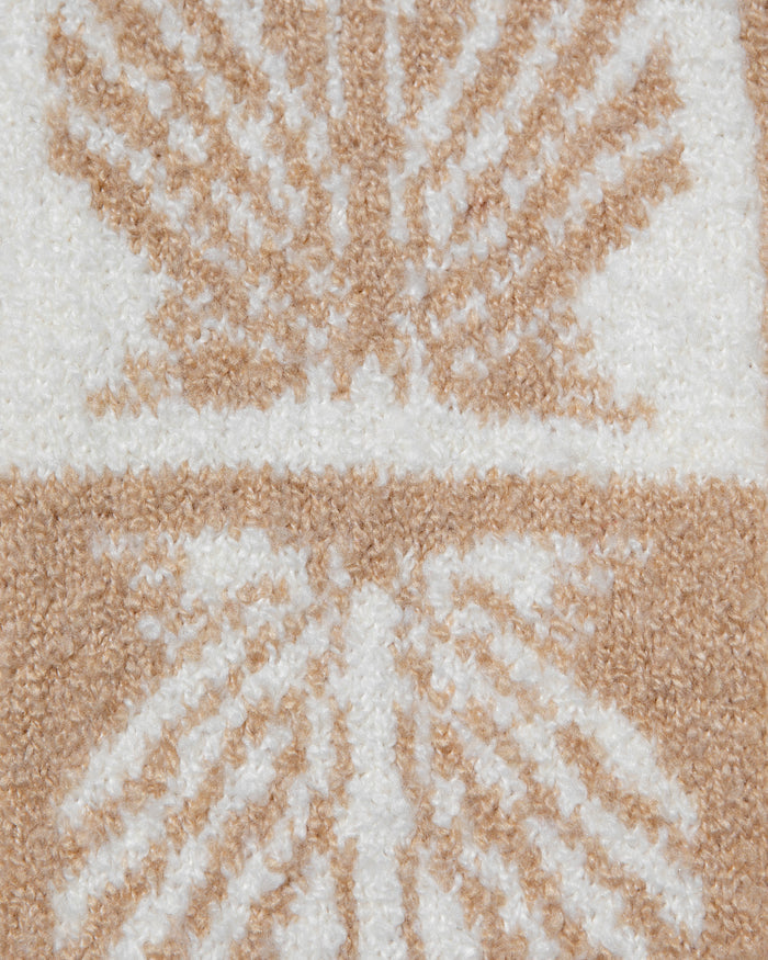 Close-up of the LSPACE Shell Be There Skirt in seashell jacquard, showing the detailed knit weave of the checkered seashell pattern in tan and cream.