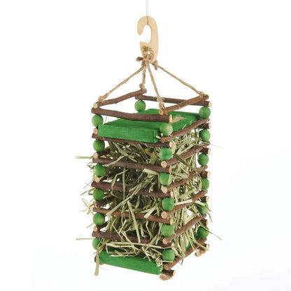Apple Stick Hay Feeder built with hay in the middle of it.