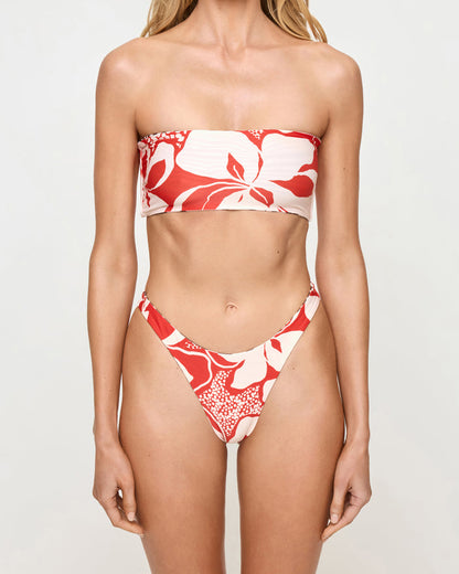 Close-up front view of a model wearing the LSPACE Animal Hibiscus Bloom Damian Bikini Bottom with the hibiscus bloom print side facing out and matching bandeau Avalon Bikini Top.