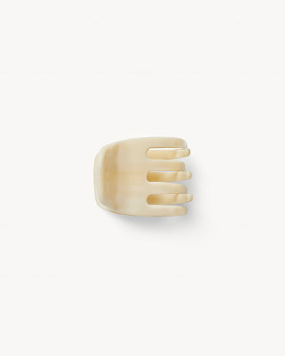 Off-model top-down view of the Machete Mini Claw in alabaster showing the teeth and solid cream acetate.
