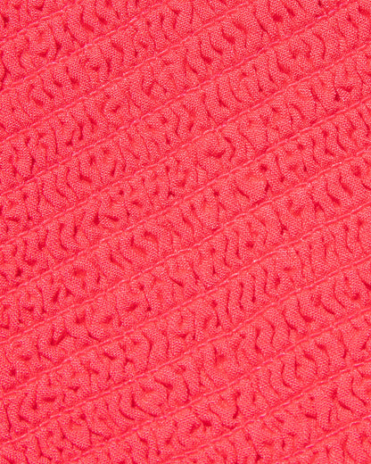 Close-up of the LSPACE Misha Midi in pout, showcasing the textured fabric in coral pink.