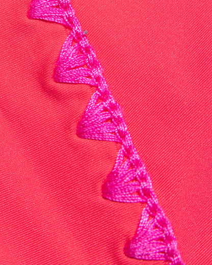 Close-up of coral pout-fuchsia fabric with bright fuchsia crochet trim, Pout-Fuschia.